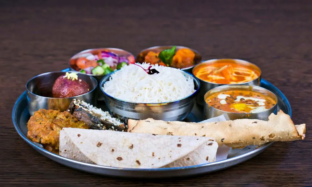Thali tray with chapati, rice and dals