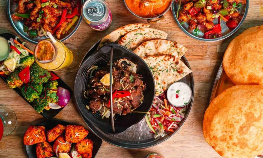 aerial view of indian breads, curries, and tikka