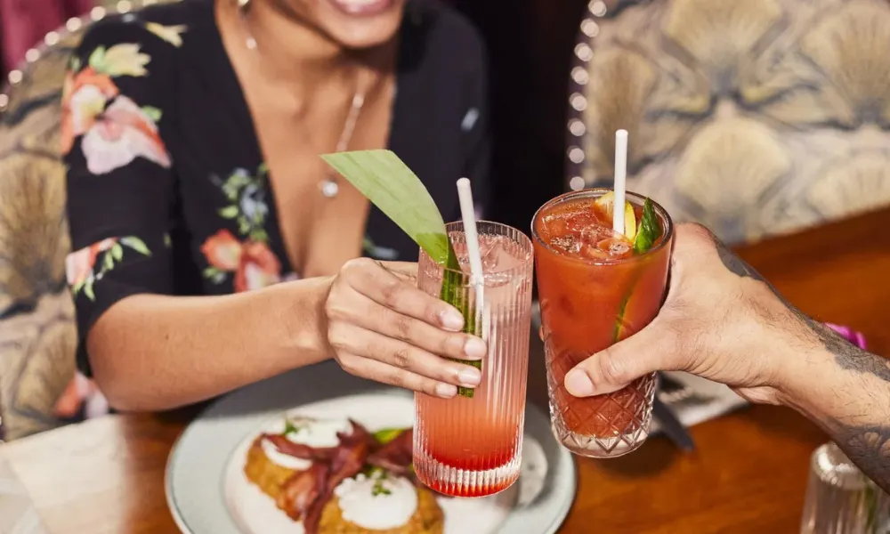 hands holding cocktails cheers glasses