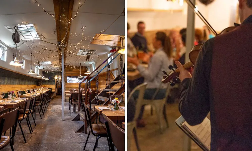 fairy lights on barge and man playing violin