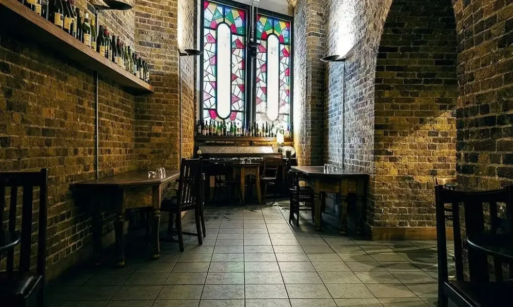 Wine bar with stained glass window and exposed brick