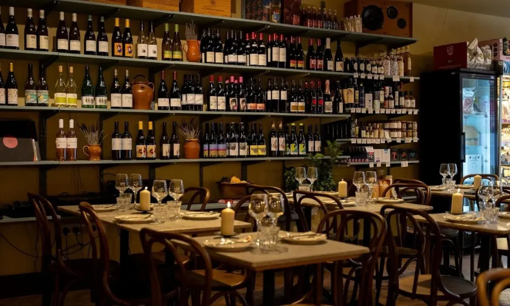 wine bar with old wood tables and shelves of wine
