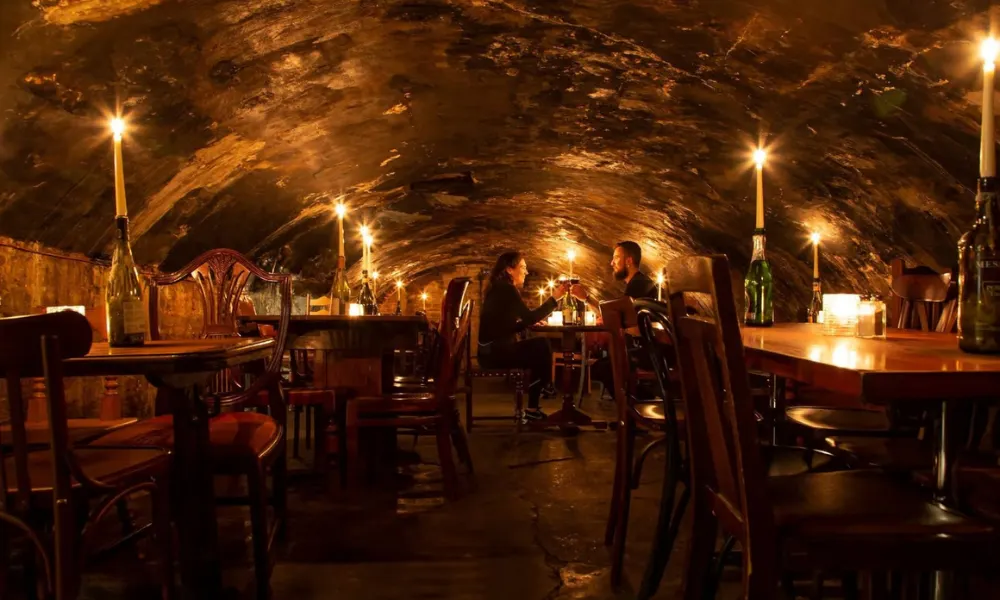 underground wine bar with candlelit tables
