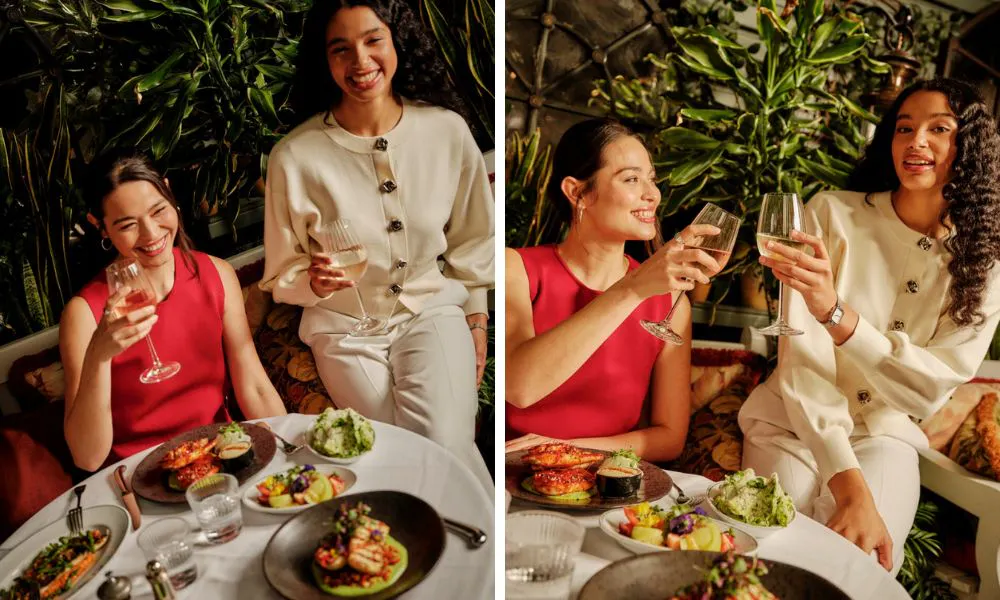 two girls enjoying wine with brunch plates