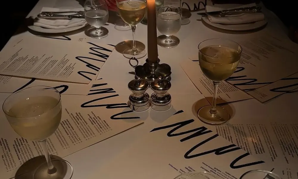 Nina table by candlelight, drinks and menus 