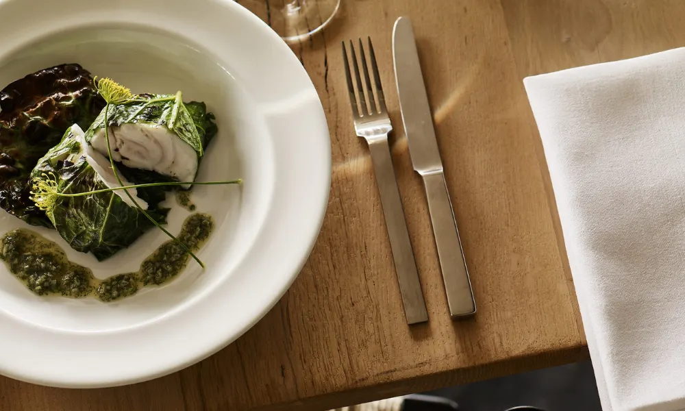 fish wrapped in leaf with green sauce