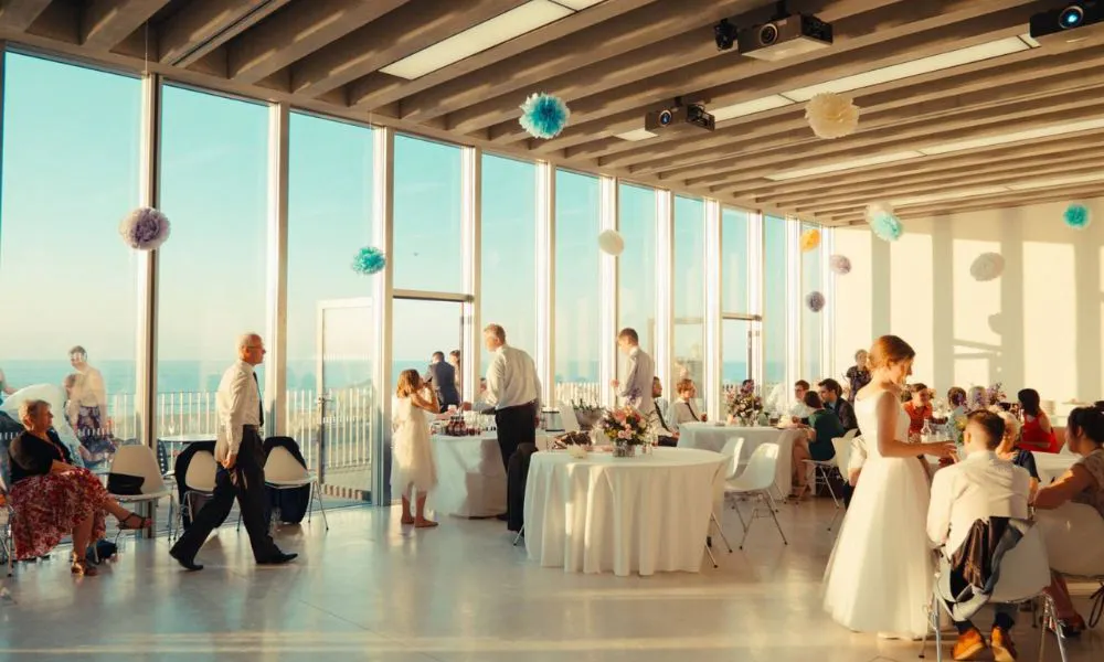 high ceiling wedding room with golden hour light and sea views