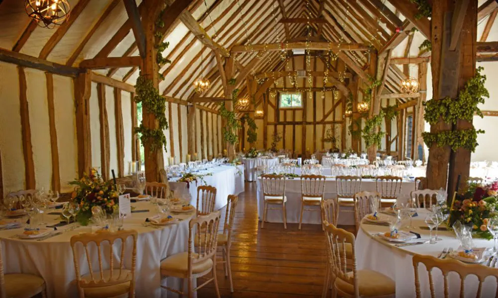 barn interior with fairy lights and exposed beams.