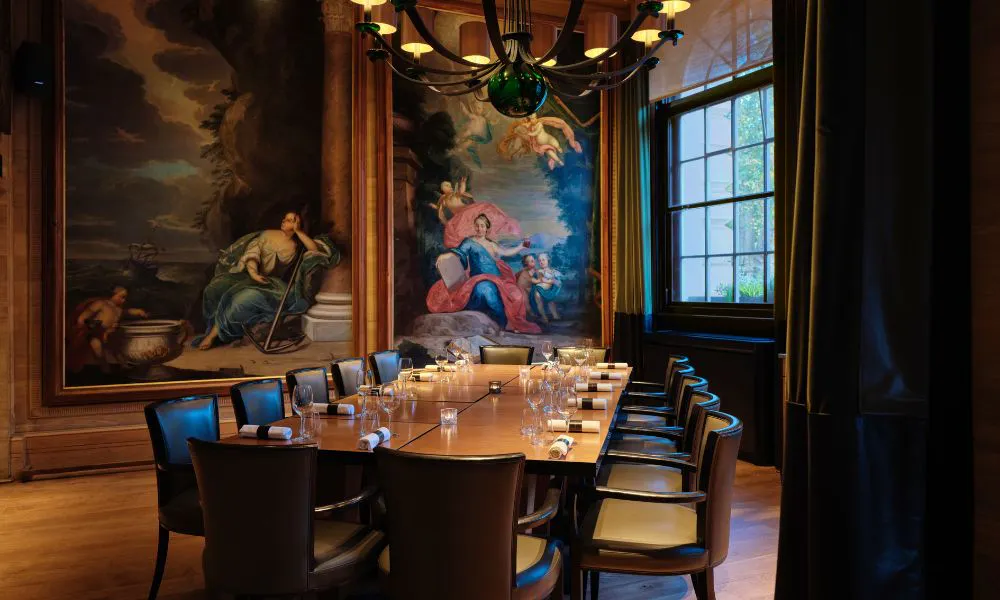 moody private dining room, with dramatic artwork on the walls