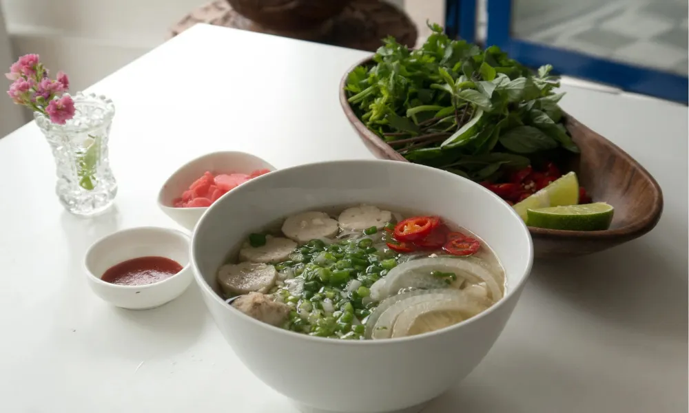 bowl of vietnamese soup noodles and sausage