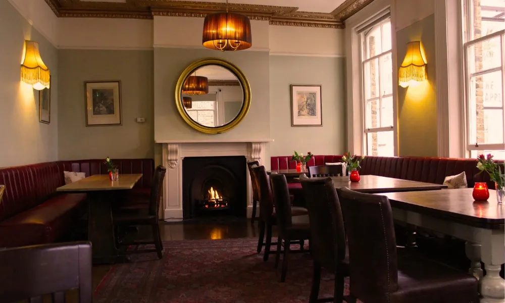 Understated pub dining room with a fire in the grate