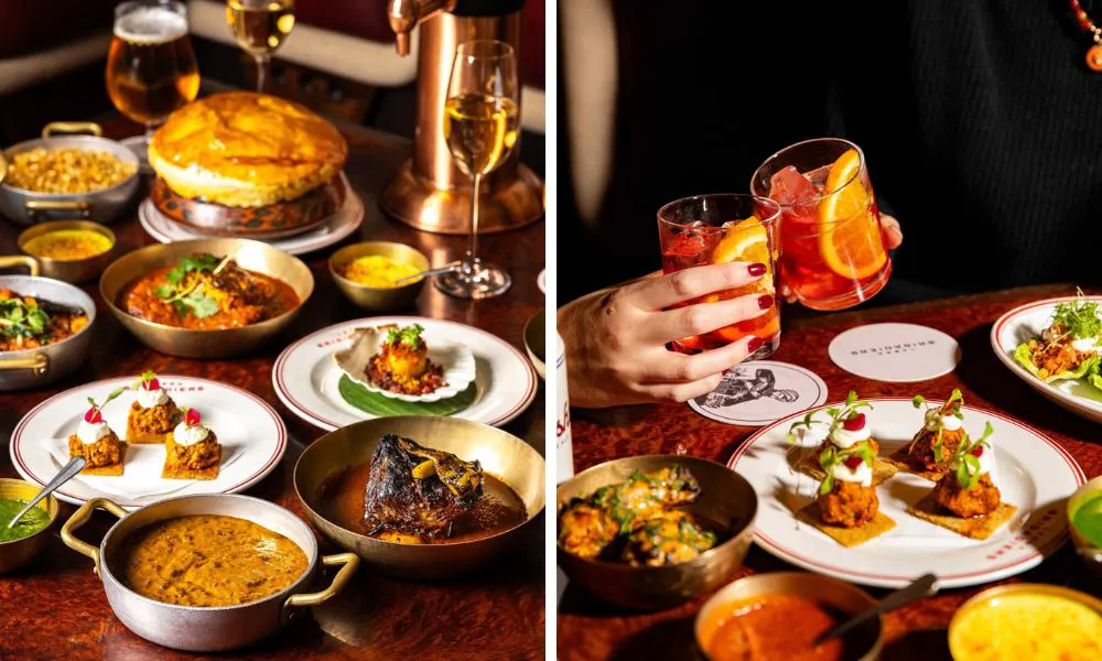 sharing menu with an array of indian dishes and two guests clinking negronis