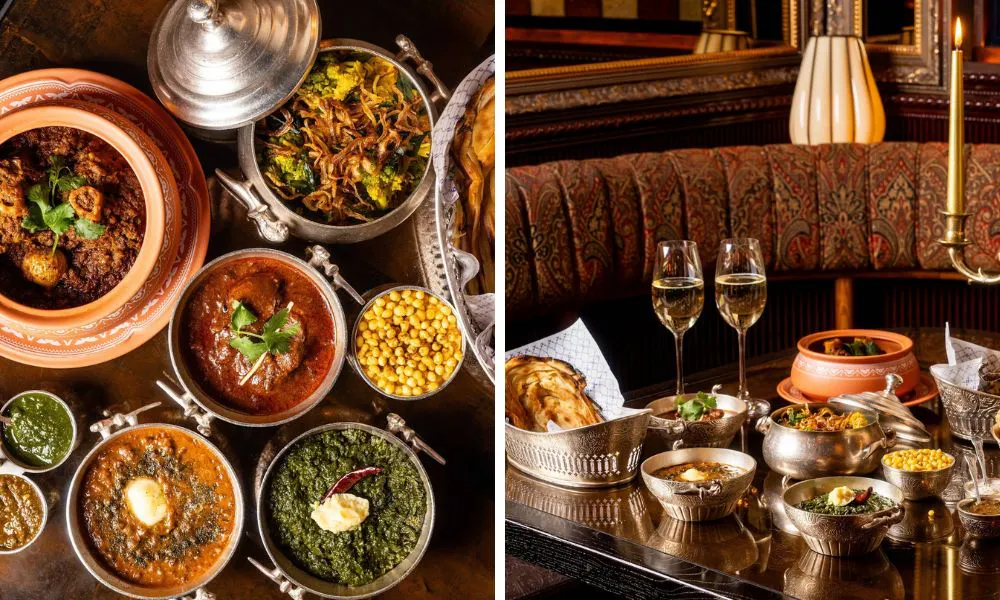 array of indian dishes spread out on table and two glasses of fizz