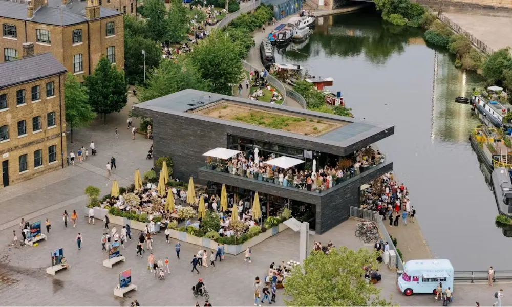people drinking in outdoor bar on canal