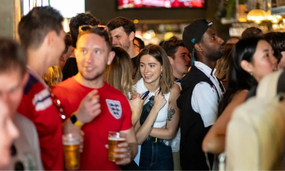 fans watching an england game in a pub