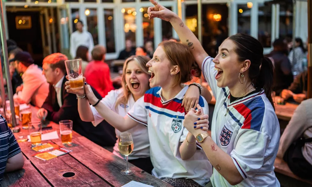 Women in england shirts cheering the world cup