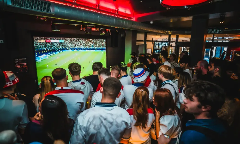 Crowds watching foodball at Belushi London Bridge