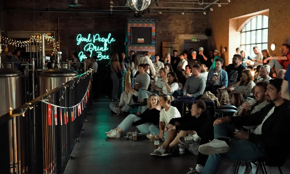 People watching football in a crowded taproom