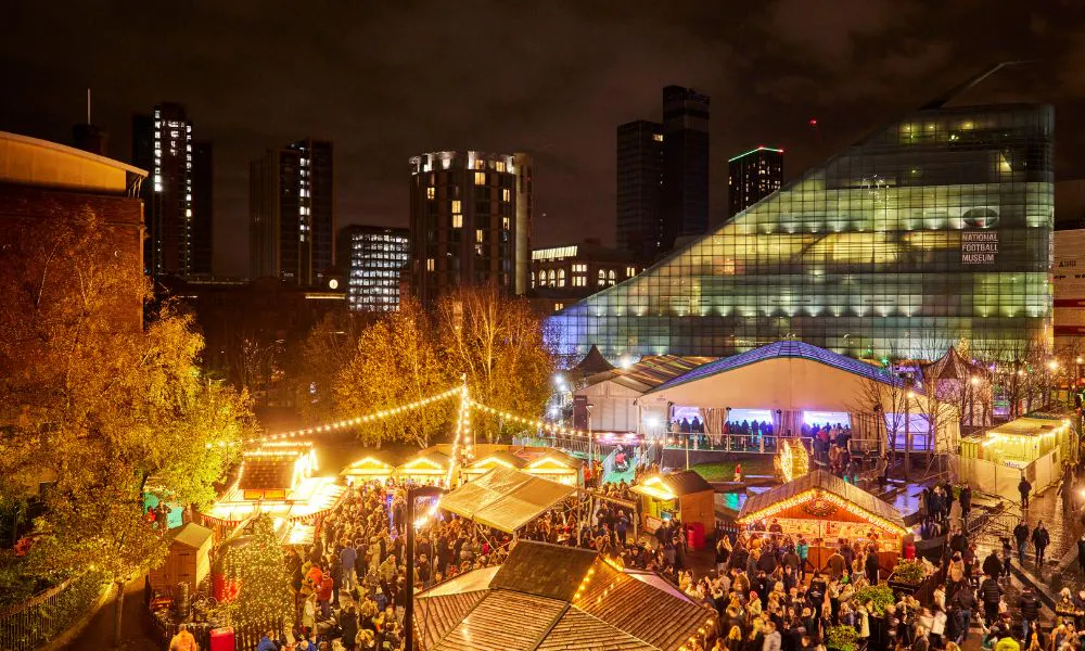 Large modern square with huts, trees, and lights