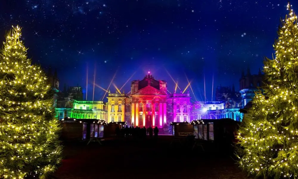 Manor house lit with rainbow coloured spotlights