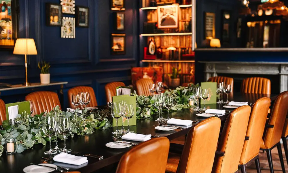 Blue dining room with wedding flowers and chairs