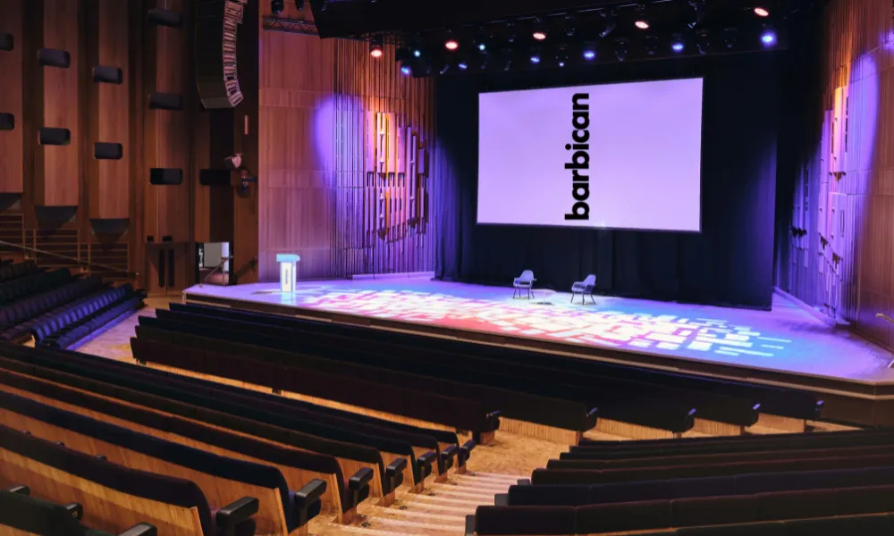 Barbican conference with stage and large projector screen 