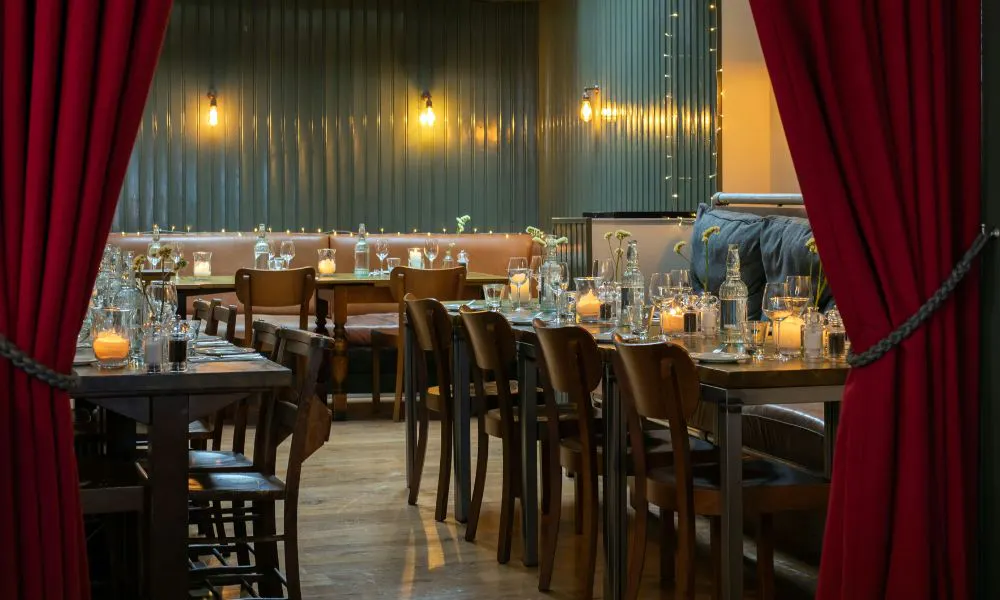 a private dining room hidden behind a red velvet curtain