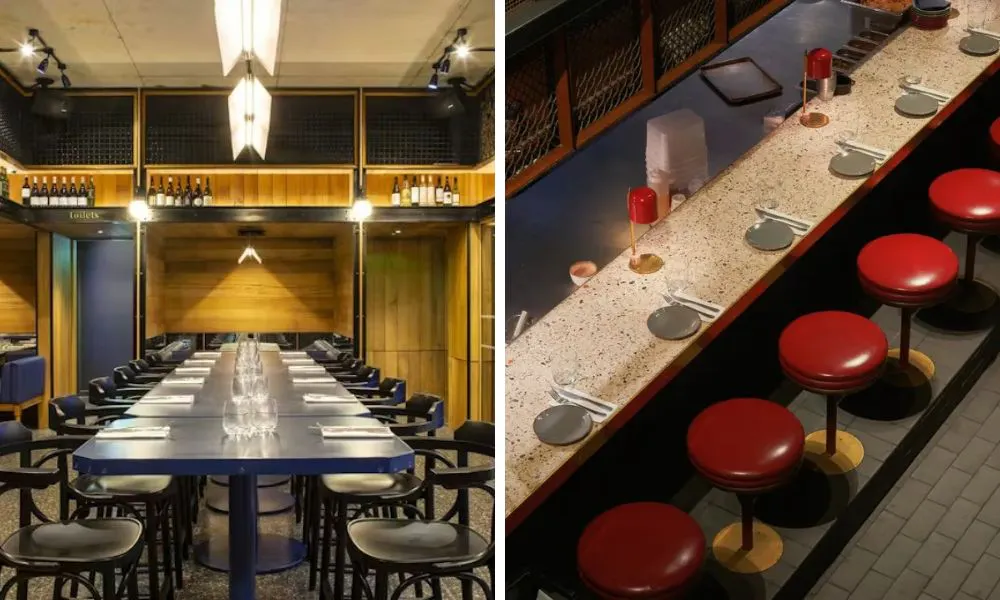 long banquet table and red stools in dining room
