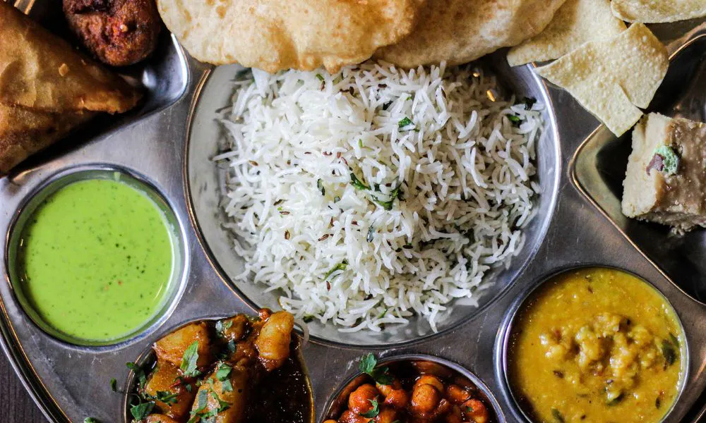 tray of rice dips and indian snacks