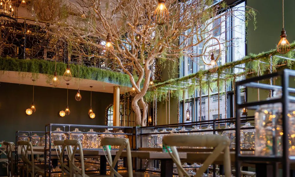 rustic restaurant interiors with life-sized tree and fairylights