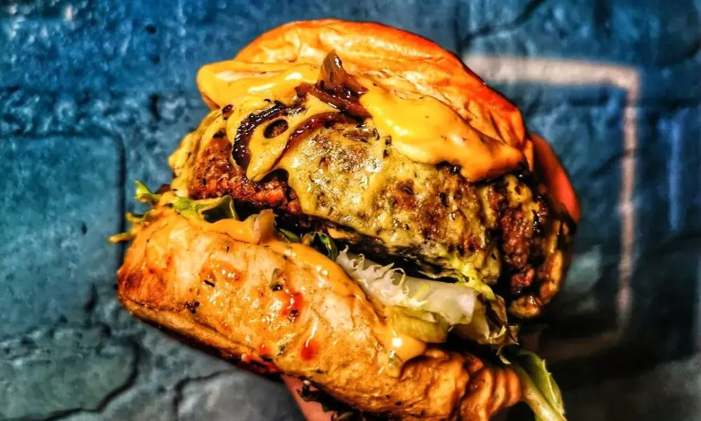 Vegetarian burger against bright blue wall