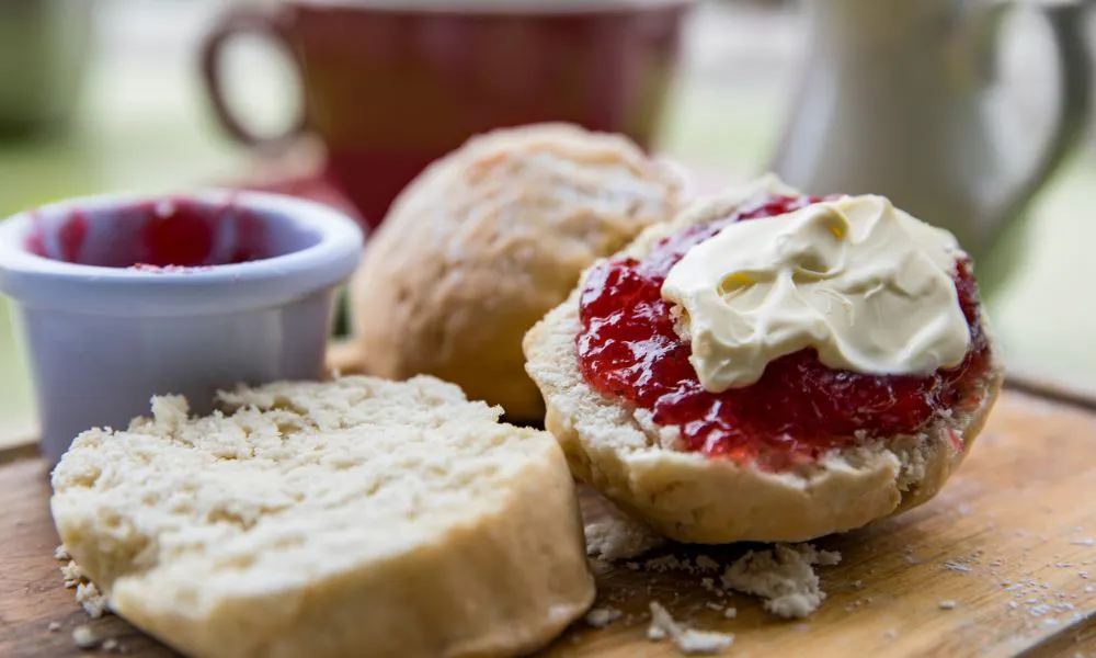 scone covered in jam and cream