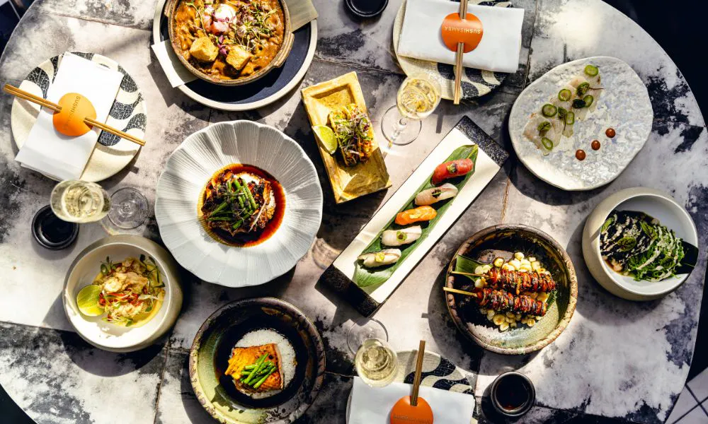 a selection of Japanese and Peruvian dishes on a table