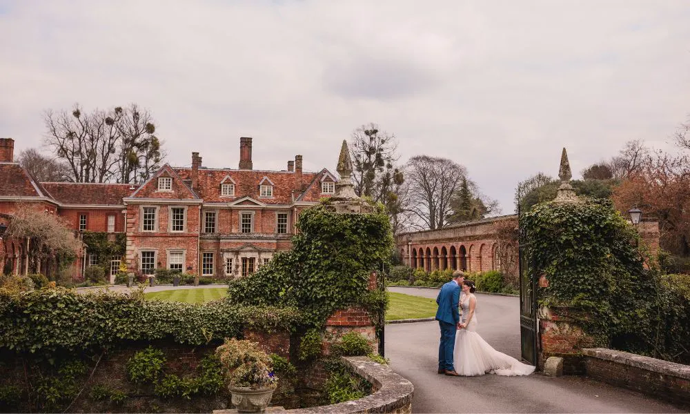 a couple in wedding attire outside Lainston House 