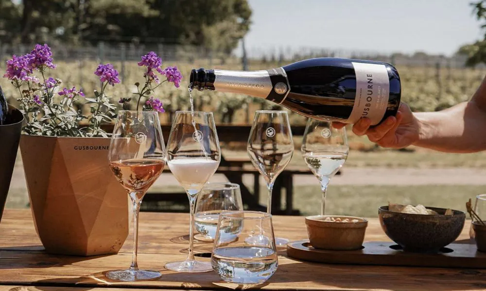 Topping up glasses of wine at Gusborne Winery