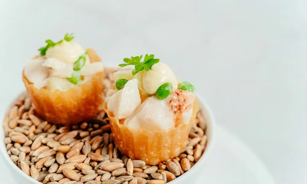 small lobster tartlets on a bed of dried seeds