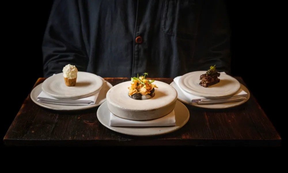 server holding tray with fine dining dishes
