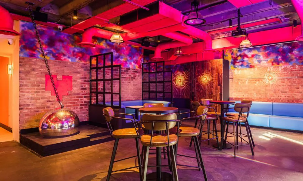 neon pink and purple room with large disco ball
