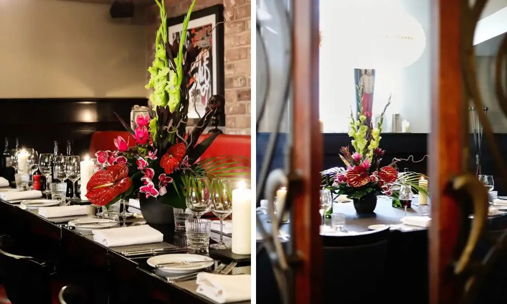 sleek, black private dining room with a vase of flowers
