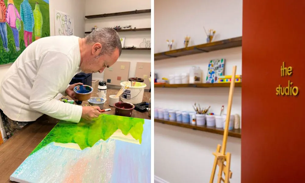 man painting a coastal landscape at art'otel battersea studio