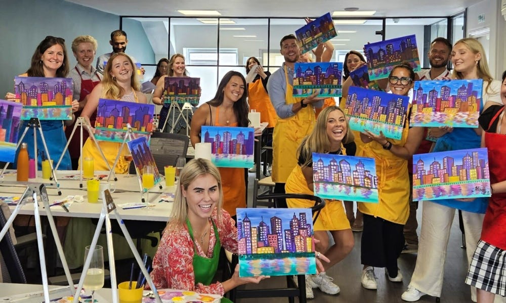 painters with their artwork at paint party social club