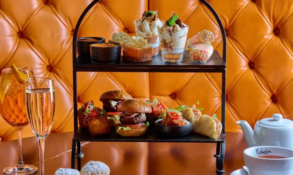 two tiered afternoon tea with glass of bubbles and tea