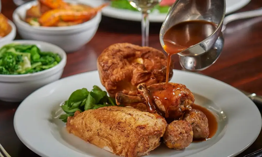 gravy poured over roast chicken dinner