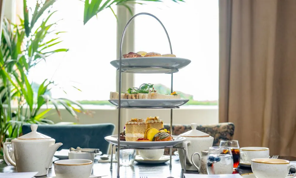 an afternoon tea stand of cakes and sandwiches