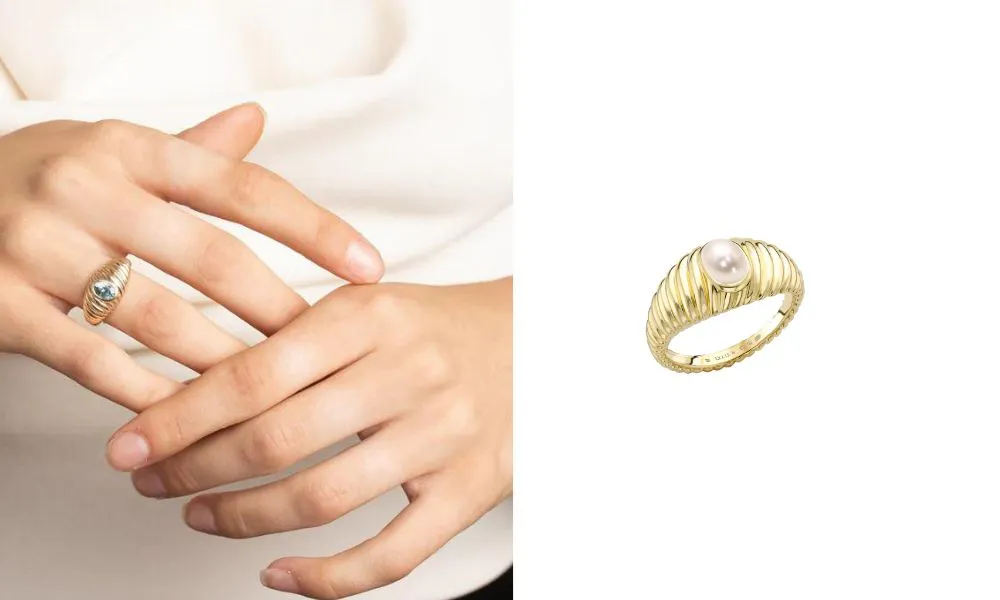 Thick gold band with waved carvings and single gemstone in the centre