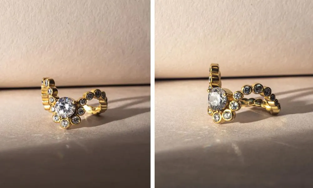 Wave shaped golden band covered with small stones with large stones surrounding large centre diamond