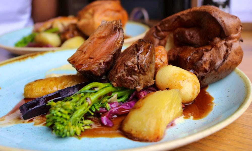 a plate of roast beef with all the trimmings