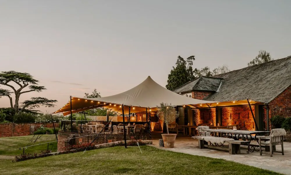 Tent extension on barn building