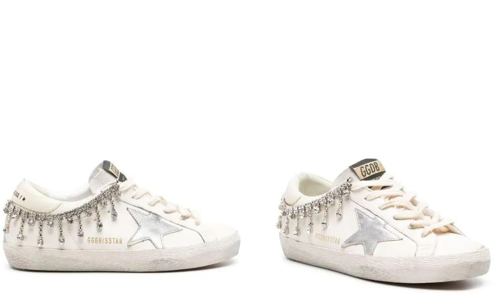 Low white sneakers decorated with diamond chain and silver star