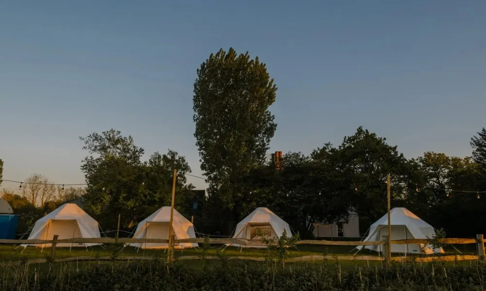 Glamping bell tents set out in a row